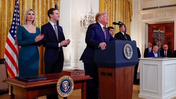 U.S. President Donald Trump is applauded by White House senior advisors Ivanka Trump and Jared Kushner prior to signing an executive order regarding combating anti-Semitism on U.S. college campuses during a during a Hanukkah reception in the East Room of the White House in Washington, U.S., December 11, 2019 - Sputnik International