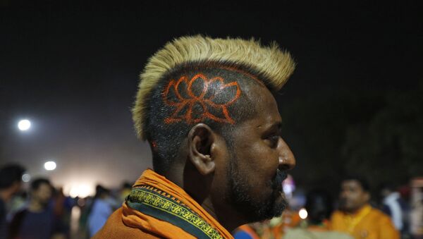 A supporter of India's Bharatiya Janata Party (BJP) Nagraj Singh displays a haircut sporting the party's symbol during an election campaign rally in Prayagraj, India, Thursday, May 9, 2019 - Sputnik International