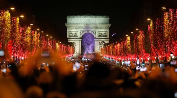 People on the Champs Elysees attend the launch of the Christmas holiday light show on the avenue leading up to the Arc de Triomphe in Paris, France, November 24, 2019 - Sputnik International