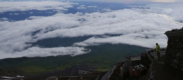 A climber views a landscape from Mount Fuji in Fujiyoshida city, Yamanashi prefecture, Japan, Thursday, July 4, 2013. Japan's most iconic landmark, Mount Fuji, the 3,776-meter-tall mountain was selected as a World Heritage site in June. A climber views a landscape from Mount Fuji in Fujiyoshida city, Yamanashi prefecture, Japan, Thursday, July 4, 2013. Japan's most iconic landmark, Mount Fuji, the 3,776-meter-tall mountain was selected as a World Heritage site in June. - Sputnik International