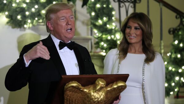 President Donald Trump speaks in the Grand Foyer of the White House during the Congressional Ball, Thursday, Dec. 12, 2019 in Washington, as First Lady Melania Trump watches. - Sputnik International