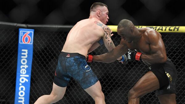 Kamaru Usman (red gloves) fights Colby Covington (blue gloves) during UFC 245 at T-Mobile Arena in Las Vegas. - Sputnik International