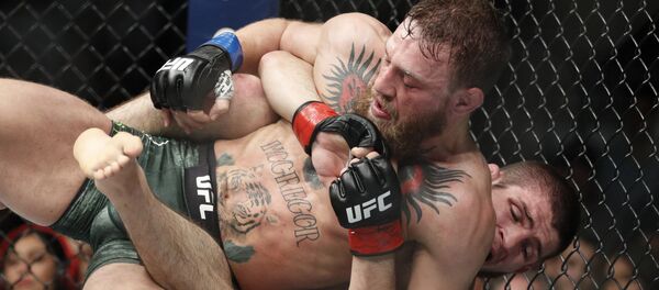 Conor McGregor, left, fights Khabib Nurmagomedov during a UFC 229 mixed martial arts bout Saturday, Oct. 6, 2018, in Las Vegas - Sputnik International