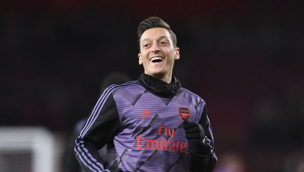 Arsenal's German midfielder Mesut Ozil warms up for the English Premier League football match between Arsenal and Manchester City at the Emirates Stadium in London on December 15, 2019 - Sputnik International