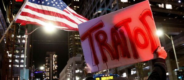 A man holds a sign reading traitor in front of an American flag as protesters take part in a rally to support the impeachment and removal of U.S. President Donald Trump outside the federal building in Seattle, Washington, U.S. December 17, 2019 - Sputnik International