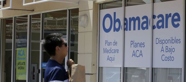 A man walks by a healthcare insurance office in Hialeah, Fla. A man walks by a healthcare insurance office in Hialeah, Fla. - Sputnik International
