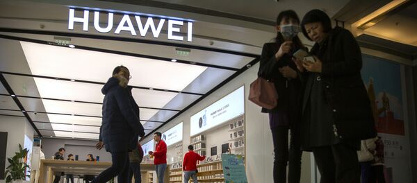 In this Nov. 20, 2019, photo, people stand outside of a Huawei store at a shopping mall in Beijing - Sputnik International