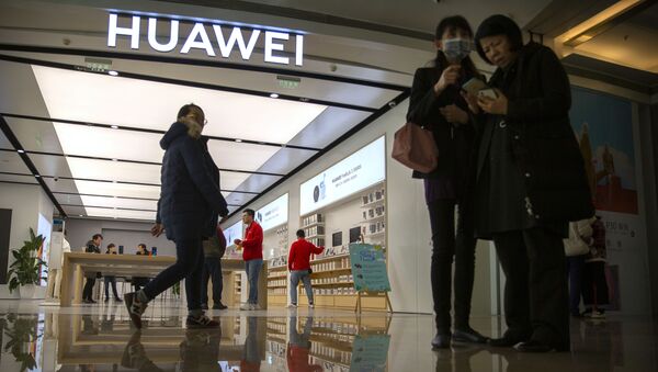 In this Nov. 20, 2019, photo, people stand outside of a Huawei store at a shopping mall in Beijing - Sputnik International