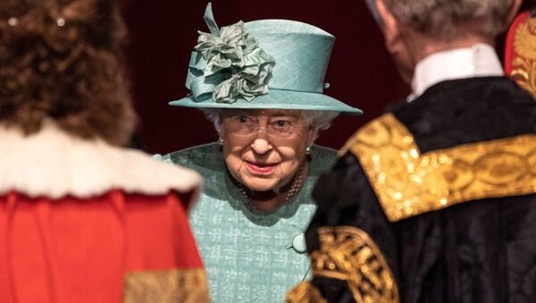 Britain's Queen Elizabeth talks with officials following her speech during at the State Opening of Parliament at the Palace of Westminster in London, Britain December 19, 2019 - Sputnik International