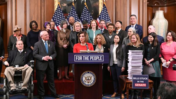 Speaker of the House Nancy Pelosi, joined by fellow Democrats, speaks next to a stack of legislation passed by the House  during a news conference at the Capitol in Washington, U.S., December 19, 2019. - Sputnik International