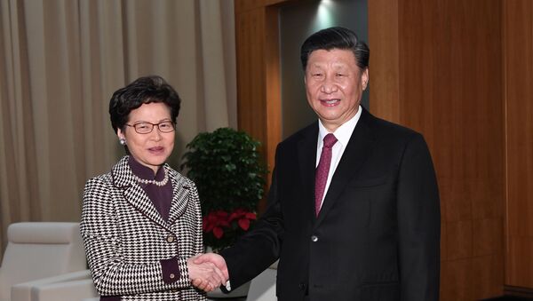 Chinese President Xi Jinping shakes hands with Hong Kong Chief Executive Carrie Lam, during their meeting on the eve of the 20th anniversary of the former Portuguese colony's return to China, in Macau, China December 19, 2019.  - Sputnik International