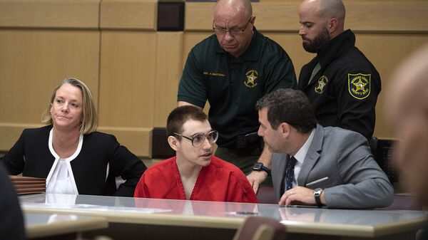 Florida school shooting defendant Nikolas Cruz speaks with attorney Gabe Ermine in Judge Elizabeth Scherer's courtroom at the Broward County Courthouse, Thursday, Dec. 19, 2019, in Fort Lauderdale, Fla. The trial of Parkland school shooting defendant Nikolas Cruz was delayed Thursday until at least next summer, when he will face a death penalty case stemming from the February 2018 massacre that left 17 people dead. - Sputnik International
