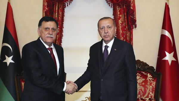 Turkey's President Recep Tayyip Erdogan, right, shakes hands with Fayez al Sarraj, the head of Libya's internationally recognised government, prior to their talks in Istanbul, Sunday, Dec. 15, 2019.  Turkey and Libya had reached an agreement on the delineation of maritime boundaries in the Mediterranean, in November. - Sputnik International