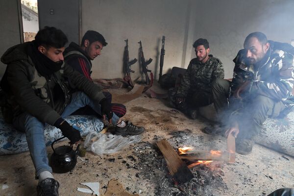 Syrian militants rest after taking part in the liberation of Sukeya village in Syria's Idlib province. - Sputnik International