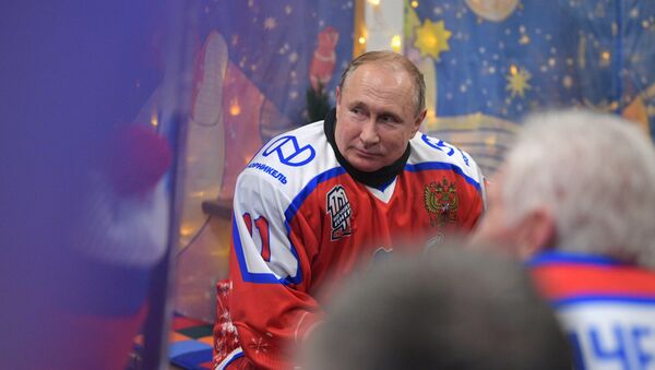 Russian President Vladimir Putin during a break in the friendly match of the Night Hockey League on the Red Square skating rink.  - Sputnik International