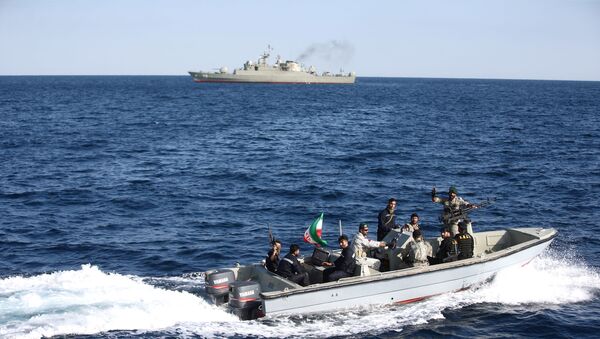 Iranian marine soldiers wave to the camera from a motor boat in the Sea of Oman during the third day of joint Iran, Russia and China naval war games - Sputnik International