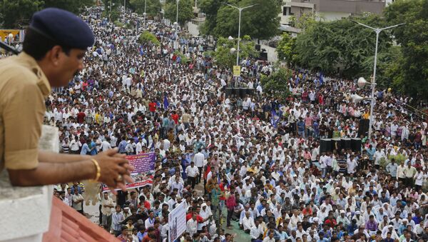 A policeman keeps vigil as hundreds of members of India's low-caste Dalit community gather for a rally to protest against the attack on their community members in Ahmadabad, India, Sunday, July 31, 2016. - Sputnik International