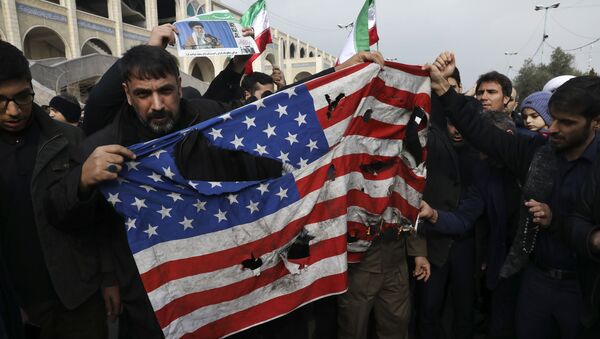 Protesters burn a U.S. flag during a demonstration over the U.S. airstrike in Iraq that killed Iranian Revolutionary Guard Gen. Qassem Soleimani, in Tehran, Iran, Jan. 3, 2020 - Sputnik International