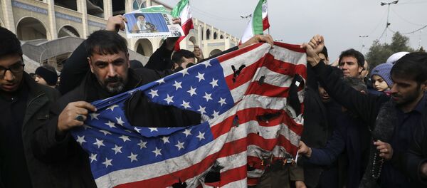 Protesters burn a U.S. flag during a demonstration over the U.S. airstrike in Iraq that killed Iranian Revolutionary Guard Gen. Qassem Soleimani, in Tehran, Iran, Jan. 3, 2020 - Sputnik International