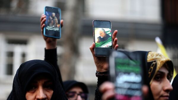 Iranian demonstrators hold up mobile phones showing the picture of the late Iranian Major-General Qassem Soleimani, during a protest against the assassination of Soleimani, head of the elite Quds Force, and Iraqi militia commander Abu Mahdi al-Muhandis, who were killed in an air strike at Baghdad airport, in front of United Nation office in Tehran, Iran January 3, 2020.  - Sputnik International