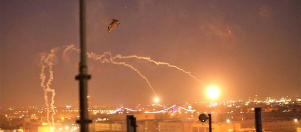 U.S. Army AH-64 Apache helicopters from 1st Battalion, 227th Aviation Regiment, 34th Combat Aviation Brigade, launch flares as they conduct overflights of the U.S. Embassy in Baghdad - Sputnik International