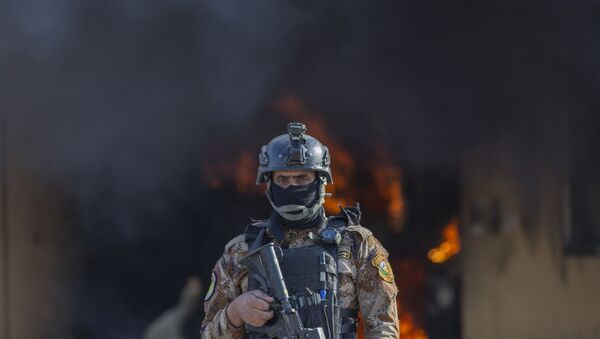 An Iraqi soldier stands guard in front of smoke rising from a fire set by pro-Iranian militiamen and their supporters in the U.S. Embassy compound, Baghdad, Iraq, Wednesday, Jan. 1, 2020. - Sputnik International