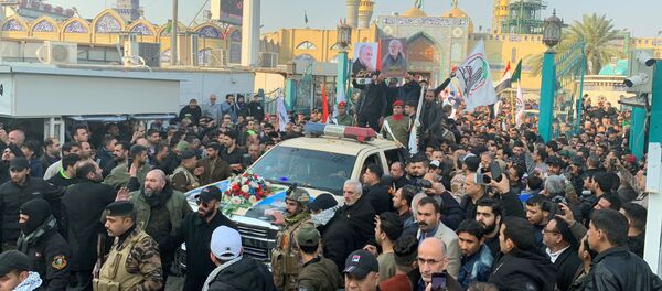 People gather at the funeral of the Iranian Major-General Qassem Soleimani, top commander of the elite Quds Force of the Revolutionary Guards, and the Iraqi militia commander Abu Mahdi al-Muhandis, who were killed in an air strike at Baghdad airport, in Baghdad, Iraq, January 4, 2020. REUTERS/Wissm al-Okili - Sputnik International