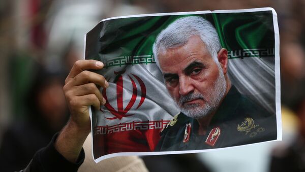 An Iranian holds a picture of late General Qassem Soleimani, head of the elite Quds Force, who was killed in an air strike at Baghdad airport, as people gather to mourn him in Tehran, Iran January 4, 2020.  - Sputnik International