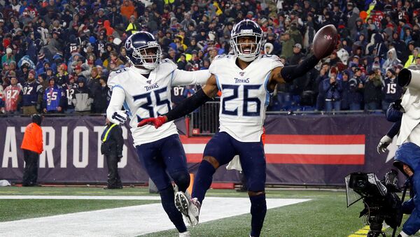 Tennessee Titans cornerback Logan Ryan (26) celebrates with defensive back Tramaine Brock (35) after scoring a touchdown on an interception against the New England Patriots during the second half at Gillette Stadium.  - Sputnik International