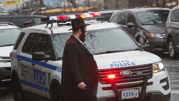 A NYPD car patrols in South Williamsburg Brooklyn on December 30, 2019 in New York City, two days after an intruder wounded five people at a rabbi's house in Monsey, New York during a gathering to celebrate the Jewish festival of Hanukkah. - Sputnik International