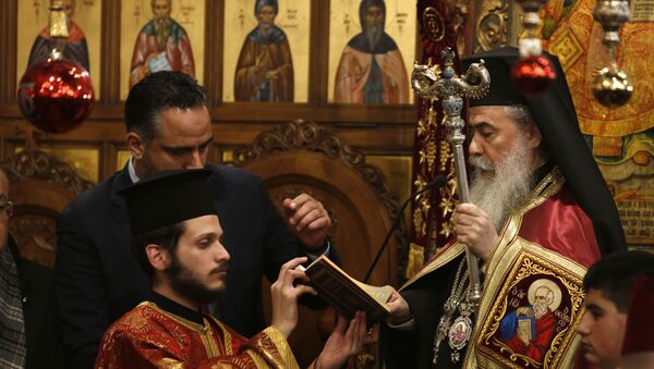 Greek Orthodox Patriarch of Jerusalem Theophilos III holds mass in the Church of the Nativity, built atop the site where Christians believe Jesus Christ was born, to celebrate Christmas according to the Eastern Orthodox calendar, in the West Bank City of Bethlehem - Sputnik International