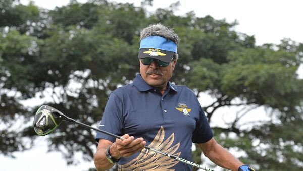 Former cricketer and golfer Kapil Dev looks on before playing a shot during the third edition of the Krishnapatnam Port Golden Eagles Golf Championship held at the Presitige Golfshire Club on the outskirts of Bangalore on November 4, 2017.  - Sputnik International