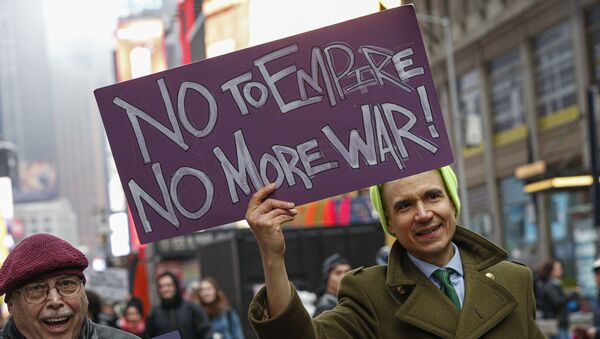 A man joins the anti-war protest at Times Square in New York on January 4, 2020. - Demonstrators are protesting the US drone attack which killed Iran's Major General Qasem Soleimani in Iraq on January 3, a dramatic escalation in spiralling tensions between Iran and the US, which pledged to send thousands more troops to the region. - Sputnik International