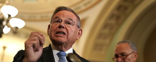 U.S. Sen. Bob Menendez speaks as Senate Minority Leader Sen. Chuck Schumer listens during a news briefing - Sputnik International