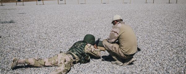 In this March 9, 2016 file image, a Dutch army trainer, right, helps a Kurdish Peshmerga soldier during a military training session at a shooting range, at Bnaslawa Military Base in Irbil, northern Iraq. In this March 9, 2016 file image, a Dutch army trainer, right, helps a Kurdish Peshmerga soldier during a military training session at a shooting range, at Bnaslawa Military Base in Irbil, northern Iraq. - Sputnik International