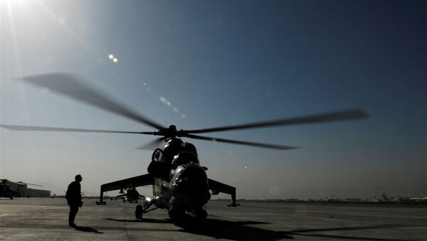 In this handout picture provided by the US Coalition Forces on June 29, 2009 and taken on May 27, 2009, a member of the Afghan Army Air Corps prepares to launch a MI-35 attack helicopter on a gunnery training mission at Kabul International Airport. - Sputnik International