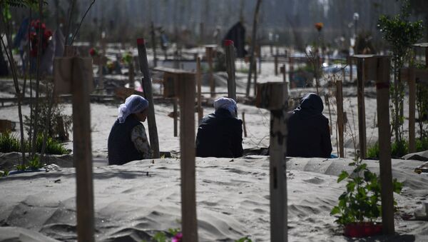 This photo taken on May 31, 2019 shows Uighur women praying in a graveyard on the outskirts of Hotan in China's northwest Xinjiang region - Sputnik International