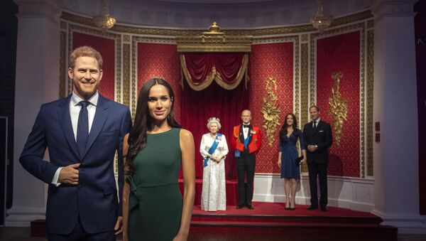 The figures of Britain's Prince Harry and Meghan, Duchess of Sussex, left, are moved from their original positions next to Queen Elizabeth II, Prince Philip and Prince William and Kate, Duchess of Cambridge, at Madame Tussauds in London, Thursday Jan. 9, 2020. Madame Tussauds moved its figures of Prince Harry and Meghan, Duchess of Sussex from its Royal Family set to elsewhere in the attraction.  - Sputnik International