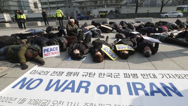 South Korean protesters lie on the ground during a rally to denounce a recent U.S. attack on Iran near the U.S. embassy in Seoul, South Korea, Friday, Jan. 10, 2020 - Sputnik International