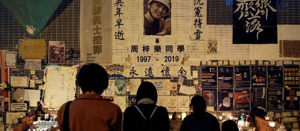 People gather near a makeshift memorial as they pay tribute to Chow Tsz-lok, 22, a university student who died two months ago after he fell from a car park during a protest, at Tseung Kwan O district in Hong Kong, China, January 8, 2020 People gather near a makeshift memorial as they pay tribute to Chow Tsz-lok, 22, a university student who died two months ago after he fell from a car park during a protest, at Tseung Kwan O district in Hong Kong, China, January 8, 2020 - Sputnik International