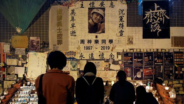 People gather near a makeshift memorial as they pay tribute to Chow Tsz-lok, 22, a university student who died two months ago after he fell from a car park during a protest, at Tseung Kwan O district in Hong Kong, China, January 8, 2020 - Sputnik International