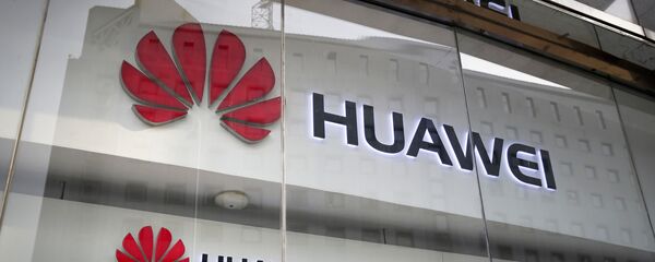 In this Jan. 29, 2019, file photo, the logos of Huawei are displayed at its retail shop window reflecting the Ministry of Foreign Affairs office in Beijing. In this Jan. 29, 2019, file photo, the logos of Huawei are displayed at its retail shop window reflecting the Ministry of Foreign Affairs office in Beijing. - Sputnik International