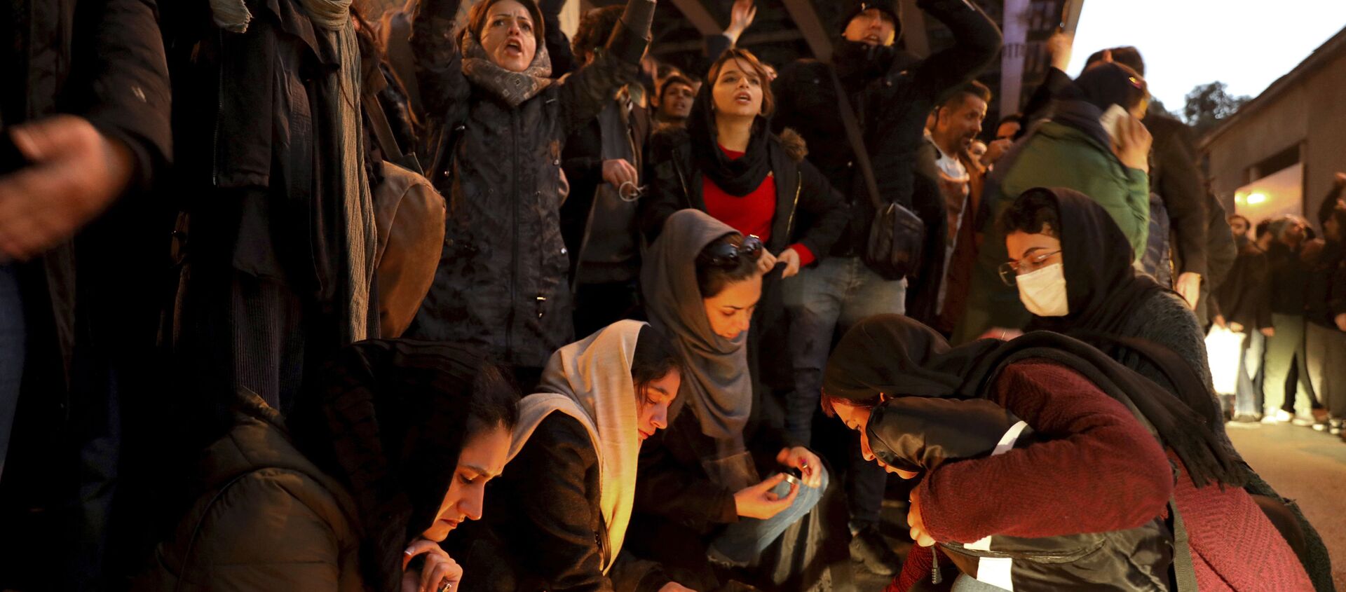 People gather for a candlelight vigil to remember the victims of the Ukraine plane crash, at the gate of Amri Kabir University, which some of the victims of the crash were former students of, in Tehran, Iran, on Saturday, 11 January 2020. On that day, Iran acknowledged that its armed forces unintentionally shot down the Ukrainian jetliner that crashed earlier this week, killing all 176 aboard, after the government had repeatedly denied Western accusations that it was responsible. - Sputnik International, 1920, 13.01.2020