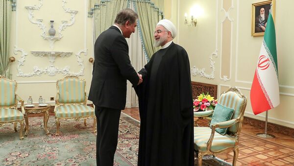 A handout picture provided by the official website of the Iranian Presidency shows Pakistan's Foreign Minister Shah Mahmood Qureshi (L) meeting with Iranian President Hassan Rouhani in Tehran on January 12, 2020 - Sputnik International