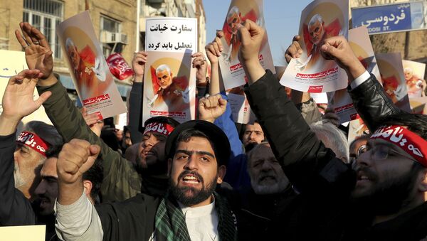 Hardline protesters chant slogans while holding up posters of Gen. Qassem Soleimani in front of British Embassy in Tehran, Iran, Sunday, Jan. 12, 2020 - Sputnik International