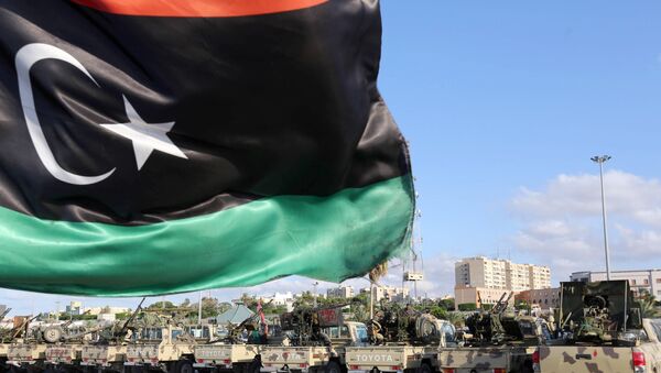 The national flag flutters as Libyan security gather in the capital Tripoli (File) - Sputnik International