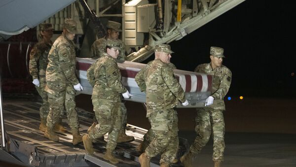 An Air Force carry team moves a transfer case containing the remains of Navy Ensign Joshua Watson on Sunday, Dec. 8, 2019, at Dover Air Force Base, Del. A Saudi gunman killed three people including 23-year-old Watson, a recent graduate of the U.S. Naval Academy from Enterprise, Ala., in a shooting at Naval Air Station Pensacola in Florida. - Sputnik International