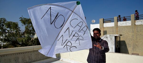 A man tries to fly a kite with a message, as part of a protest against a new citizenship law, on the occasion of kite flying festival, locally known as Uttarayan, in Ahmedabad, India, January 14, 2020 - Sputnik International
