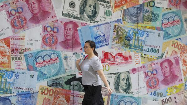 A woman walks by a money exchange shop decorated with different countries currency banknotes at Central, a business district in Hong Kong, Tuesday, Aug. 6, 2019 - Sputnik International