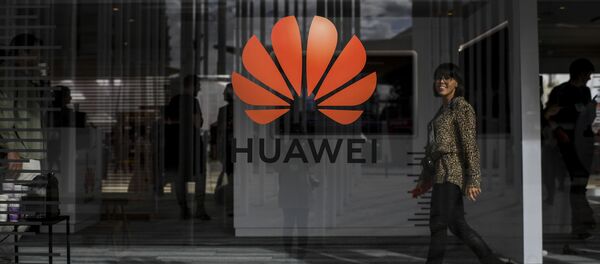 A woman walks past the logo of Chinese telecom giant Huawei during the Web Summit in Lisbon on November 6, 2019 A woman walks past the logo of Chinese telecom giant Huawei during the Web Summit in Lisbon on November 6, 2019 - Sputnik International